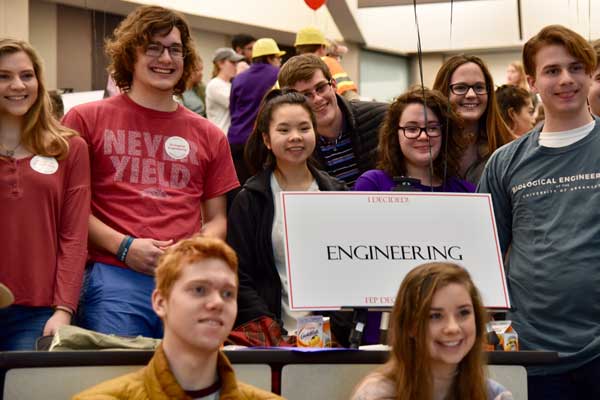 students gathered around engineering sign on decision day